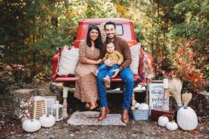 Photo of a family sitting on a Red Ford Truck for Fall Family Photos by Caryn Scanlan