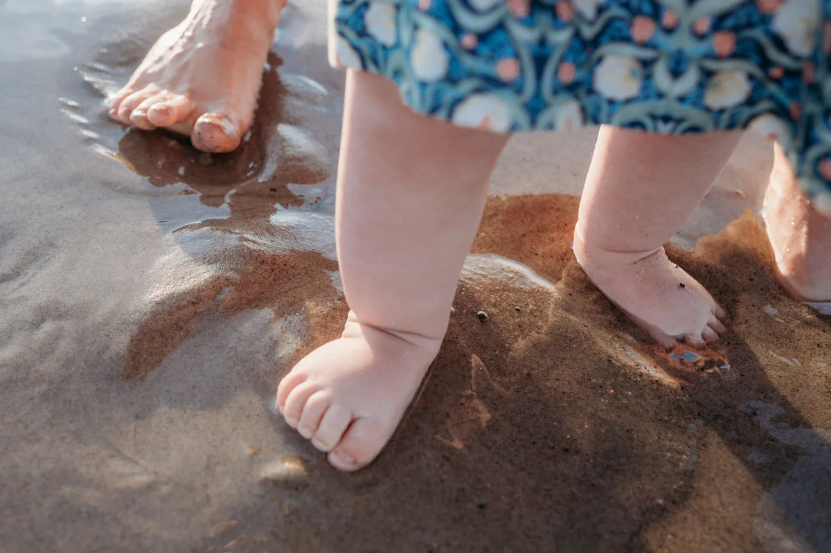 Plymouth Family Photographer Caryn Scanlan photographed this mom and her baby at a family photoshoot on a beach on the South Shore near Plymouth, MA