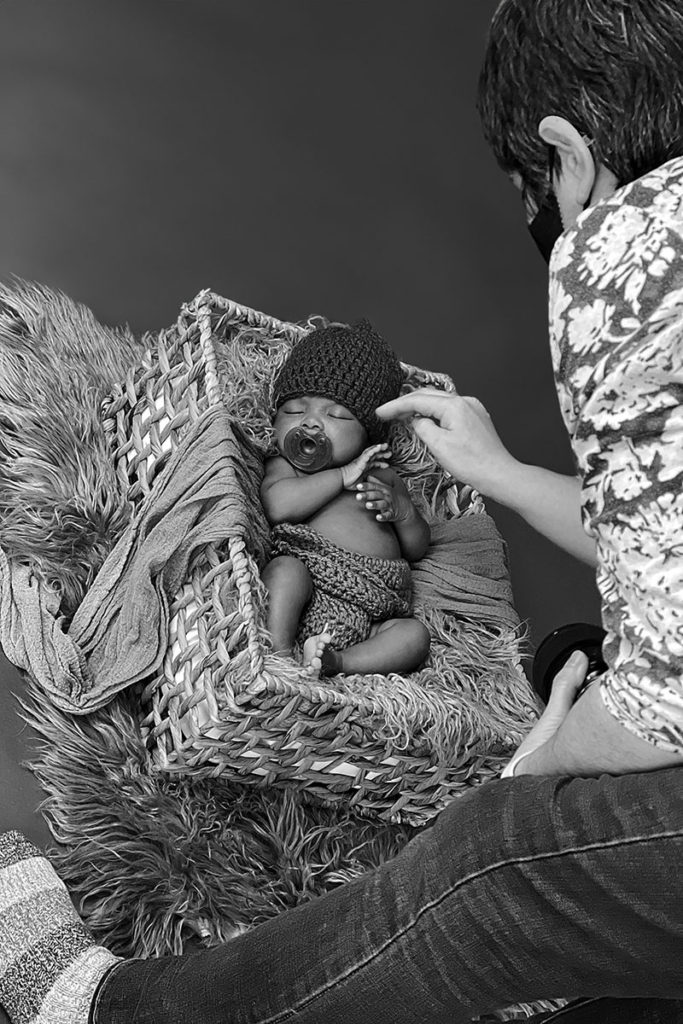 Caryn Scanlan, Plymouth Newborn Photographer, working with a newborn in her studio on the South Shore, MA