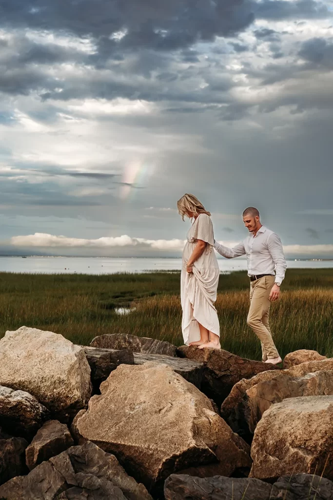 Caryn Scanlan Cape Cod Maternity photographer on the beach with a cloudy, stormy sky and a rainbow