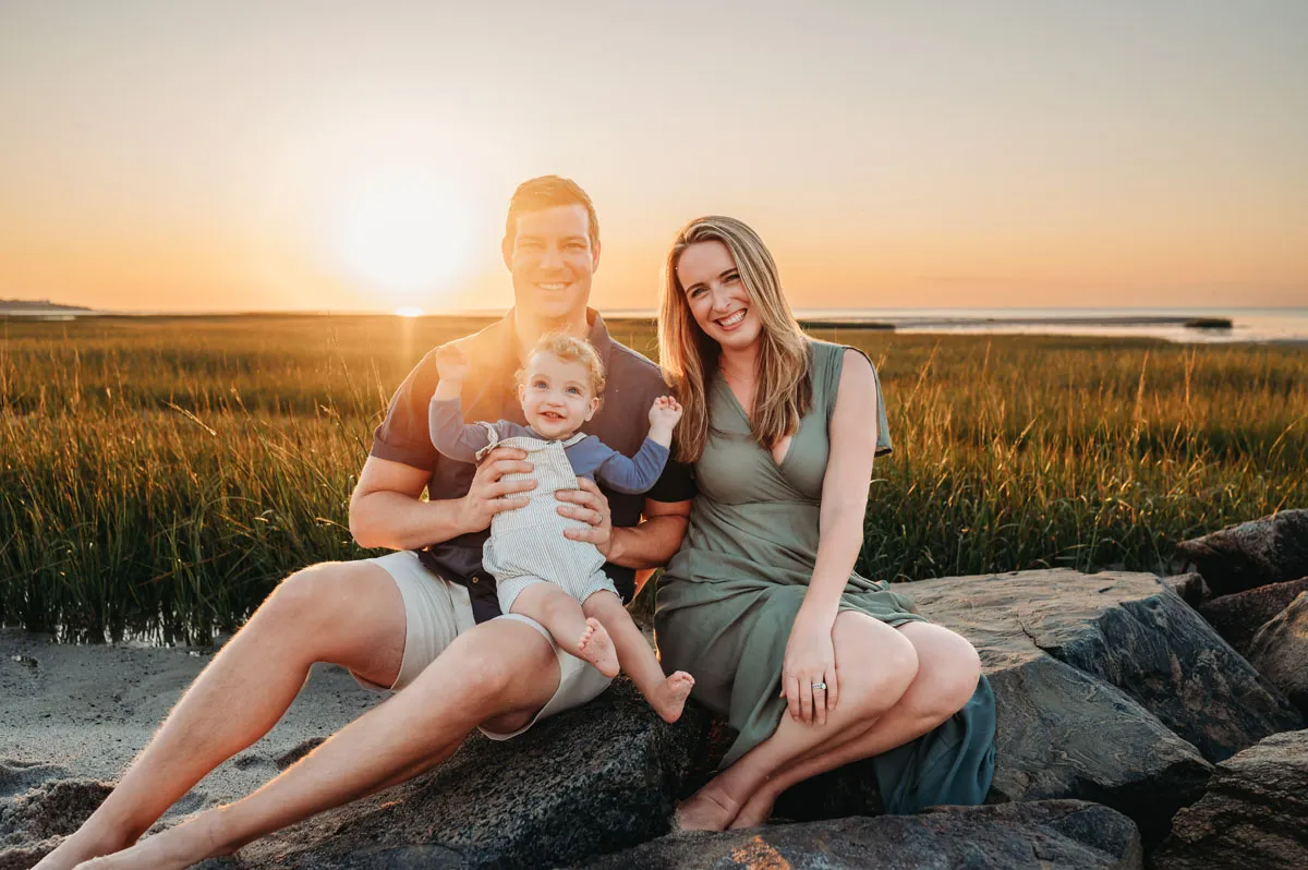 Caryn Scanlan Cape Cod Photographer Family sitting on rocks on the beach at Sunset