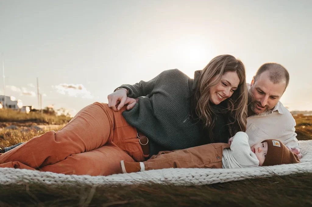 Cape Cod Family Photographer Cary nScanlan with a family on a blanket on the beach